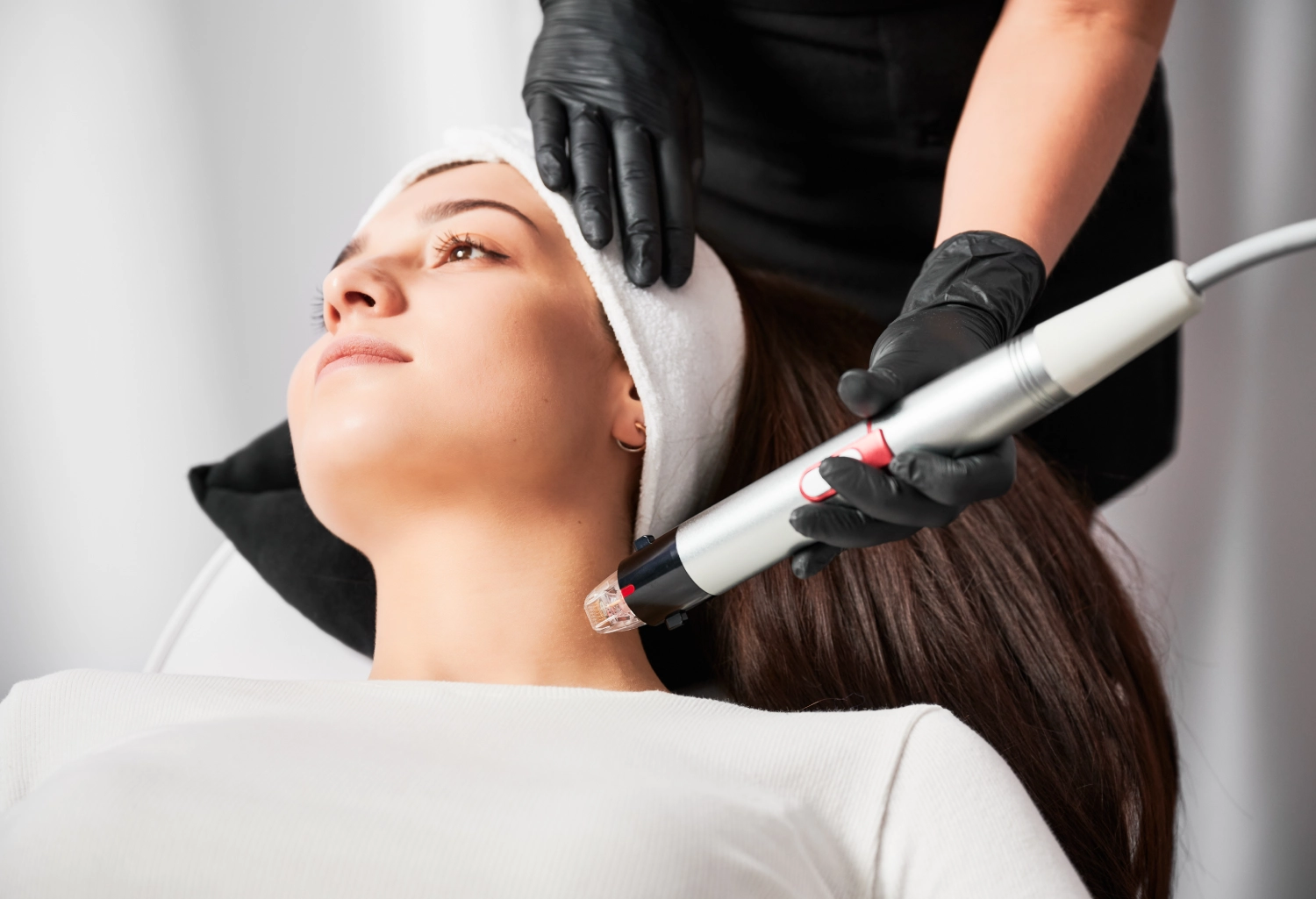 Woman Getting RF Microneedling at The Aesthetic Center